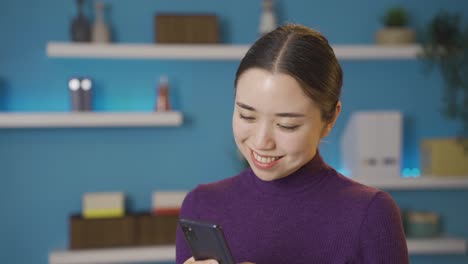 Asian-happy-woman-talking-to-someone-on-her-phone.